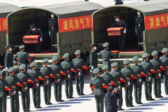 Chinese honour guards carry caskets containing the remains of Chinese soldiers killed during the 1950-53 Korean War at the Shenyang Taoxian International Airport in Shenyang in China's northeastern Liaoning province on September 2, 2021, after the remains were returned from South Korea for permanent burial. (Photo by AFP Photo/China Stringer Network)