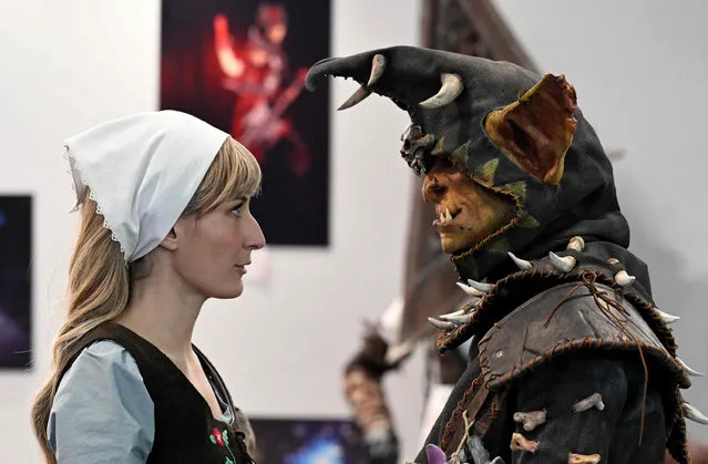 Two costumed participants attend the opening day of the “Paris Games Week” video-game fair, after the cancellation of two editions due to the pandemic, in Paris on November 2, 2022. The largest French video game fair, Paris Games Week, is open on November 2 to 6. If video games remain the preferred digital leisure activity of young people, with 95% of 10-17 year olds playing them, the practice concerns more than 37 million French people, 53% even declaring that they play them “at least once a week”, according to the Syndicat des editeurs de logiciels de loisirs (Leisure software editors union)(Sell). (Photo by Emmanuel Dunand/AFP Photo)