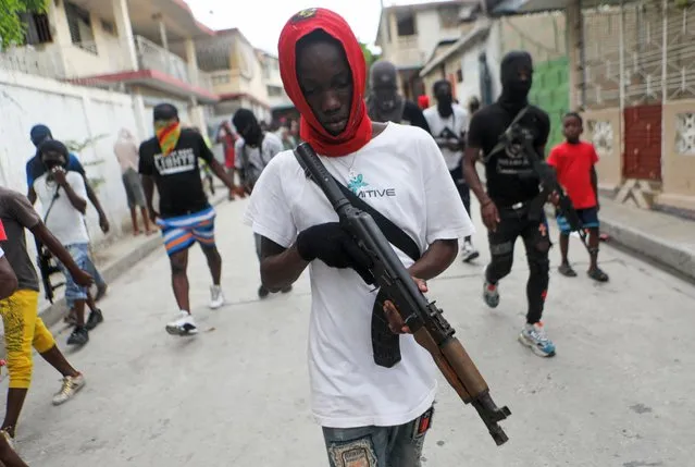 Former police officer Jimmy “Barbecue” Cherizier (not pictured), leader of the 'G9' coalition, is accompanied by Security during a march against Haiti's Prime Minister Ariel Henry, in Port-au-Prince, Haiti September 19, 2023. (Photo by Ralph Tedy Erol/Reuters)