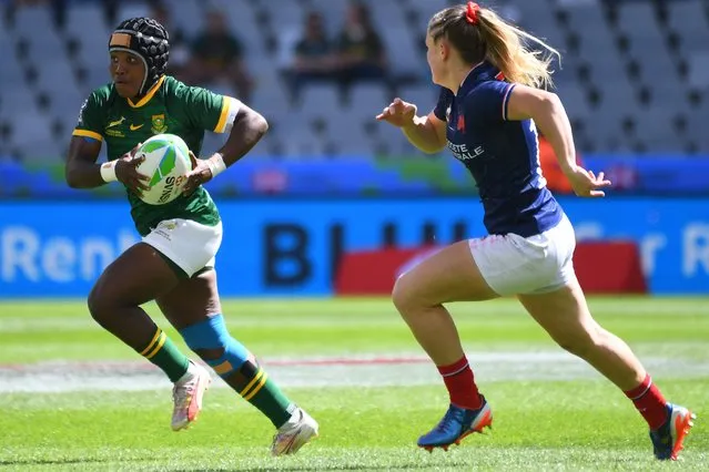 France's Chloe Jacquet (R) runs to tackle South Africa's Simamkele Namba (L) during the women's HSBC World Rugby Sevens Series 2023 pool C match between France and South Africa at the Cape Town stadium in Cape Town on December 9, 2023. (Photo by Rodger Bosch/AFP Photo)