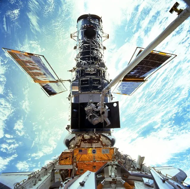 In this image provided by NASA/JSC, astronauts Steven L. Smith and John M. Grunsfeld are photographed during an extravehicular activity (EVA) during the December 1999 Hubble servicing mission of STS-103, flown by Discovery. The Hubble Space Telescope, one of NASA'S crowning glories, marks its 25th anniversary on Friday, April 24, 2015. (Photo by NASA/JSC via AP Photo)