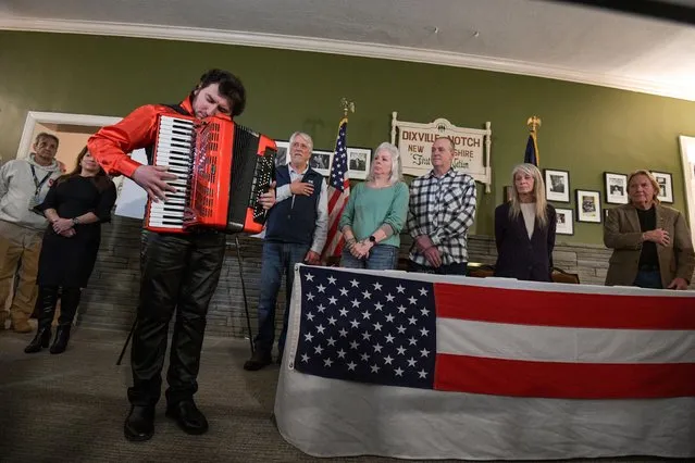 Cory Pesaturo plays the national anthem on accordion to start voting after midnight on the day of the U.S. presidential primary election in the living room of the Tillotson House at Balsams Hotel in Dixville Notch, New Hampshire, U.S., January 23, 2024. (Photo by Faith Ninivaggi/Reuters)