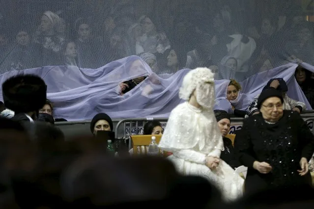 An ultra-Orthodox Jewish bride takes part in the "mitzva tantz", the custom in which relatives dance in front of the bride after her wedding ceremony, in Netanya, Israel, late March 15, 2016. (Photo by Baz Ratner/Reuters)