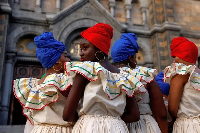 Members of a Haitian dance group wait to perform during the first of an annual community event since the coronavirus disease (COVID-19) pandemic, outside the Basilica and Shrine of Our Lady of Perpetual Help in the Mission Hill neighborhood of Boston, Massachusetts, U.S., October 16, 2021. (Photo by Shannon Stapleton/Reuters)