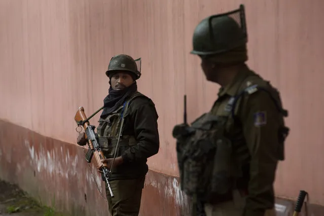 Indian paramilitary soldiers stand guard outside a polling station on the eve of the second phase of India's general election in Srinagar, Indian controlled Kashmir, Wednesday, April 17, 2019. With 900 million of India's 1.3 billion people registered to vote, the Indian national election is the world's largest democratic exercise. (Photo by Dar Yasin/AP Photo)