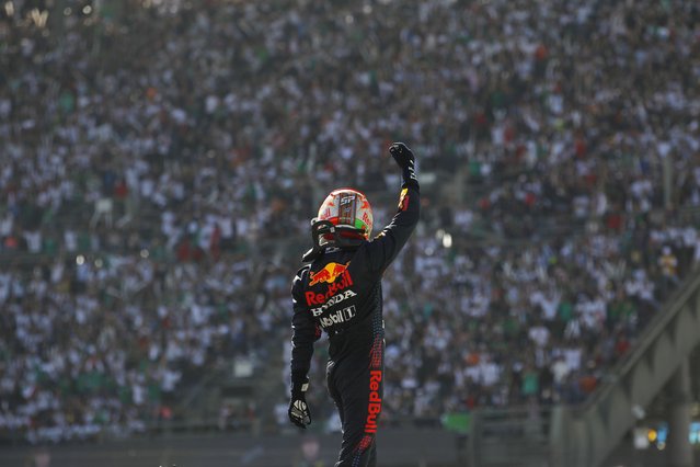 Red Bull driver Sergio Perez, of Mexico, celebrates his third place finish in the Formula One Mexico Grand Prix auto race at the Hermanos Rodriguez racetrack in Mexico City, Sunday, November 7, 2021. (Photo by Francisco Guasco/Pool Photo via AP Photo)
