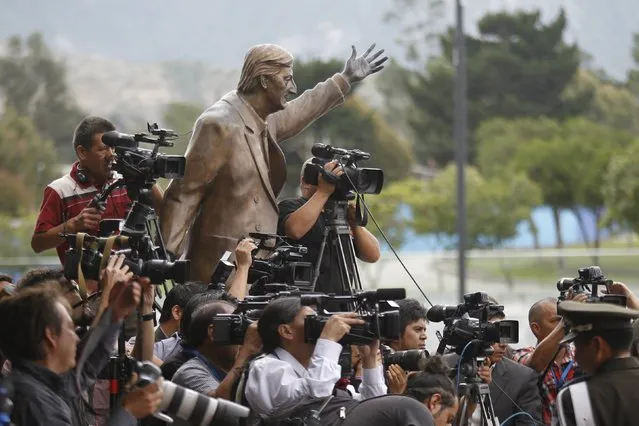 A statue of Nestor Kirchner is seen among a group of journalists during the summit of Delegations from Latin American oil exporters from Colombia, Ecuador, Mexico and Venezuela at the UNASUR headquarter in Quito, Ecuador April 8, 2016. (Photo by Guillermo Granja/Reuters)