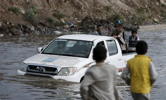 A vehicle drives in floodwaters during a rainy day in Yemen's capital Sanaa April 9, 2016. (Photo by Khaled Abdullah/Reuters)