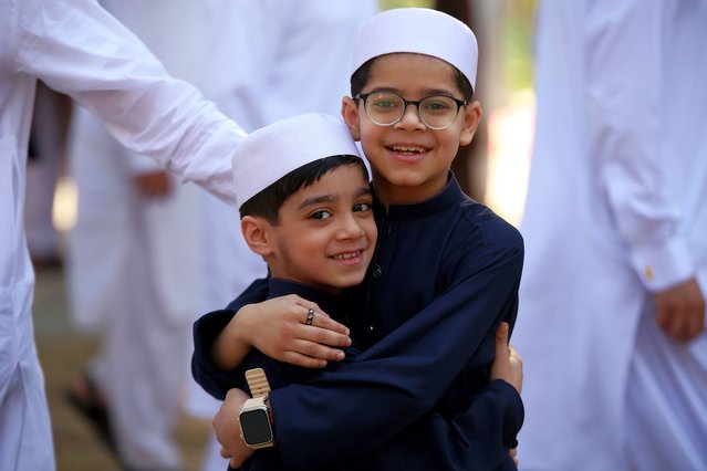 Pakistani Muslims children greet each other after the Eid al-Fitr prayers in Peshawar, Pakistan, 10 April 2024. Muslims worldwide celebrate Eid al-Fitr, a two or three-day festival, at the end of the Muslim holy fasting month of Ramadan. It is one of the two major holidays in Islam. During Eid al-Fitr, most people travel to visit each other in town or outside of it and children receive new clothes and money to spend for the occasion. (Photo by Bilawal Arbab/EPA/EFE)