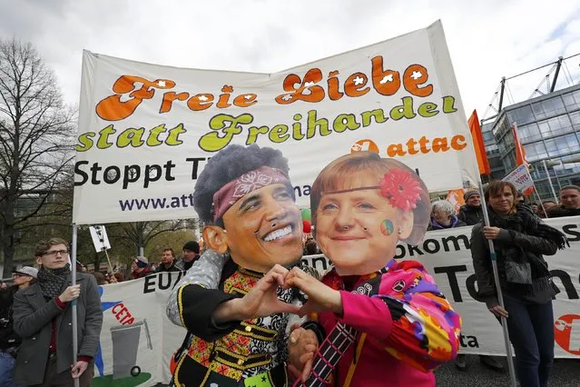 Protesters wearing masks depicting German Chancellor Angela Merkel and U.S. President Barack Obama as they demonstrate against Transatlantic Trade and Investment Partnership (TTIP) agreement ahead of Obama's visit in Hannover, Germany April 23, 2016. (Photo by Kai Pfaffenbach/Reuters)