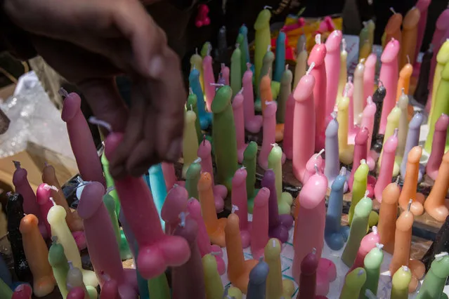 A man buys a phallic-shaped candle at the Wakamiya Hachimangu shrine during Kanamara Matsuri (Festival of the Steel Phallus) on April 6, 2014 in Kawasaki, Japan. The Kanamara Festival is held annually on the first Sunday of April. (Photo by Chris McGrath/Getty Images)