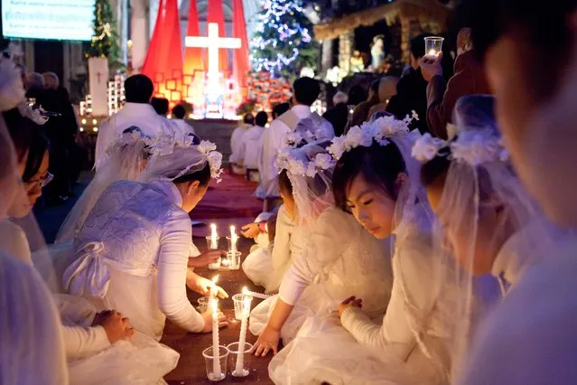 “Christmas Angels”. Girls in white gown were participating the Christmas mass in front of the St Joseph's Cathedral of Hanoi. Photo location: Hanoi, Vietnam. (Photo and caption by Sai Kit Leung/National Geographic Photo Contest)