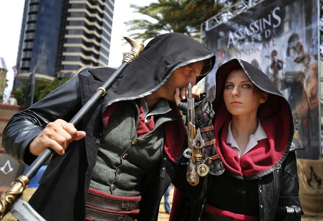 Jacob and Evie Frye from Assassin's Creed Syndicate share a secret at the Assassin's Creed Experience 2015 during San Diego Comic-Con Sunday, July 12, 2015, in San Diego. (Photo by Jack Dempsey/Invision for Ubisoft/AP Images)