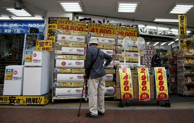 A man looks at air conditioners outside a discount electronics store at a shopping district in Tokyo, Japan, April 28, 2015. (Photo by Yuya Shino/Reuters)
