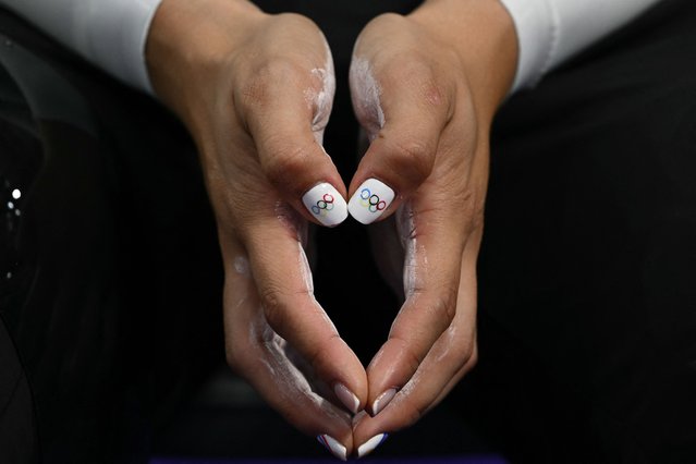 A photo shows the Olympic Rings-themed painted nails of Mexico's Yuli Paola Verdugo Osuna during a track cycling session of the Paris 2024 Olympic Games at the Saint-Quentin-en-Yvelines National Velodrome in Montigny-le-Bretonneux, south-west of Paris, on August 7, 2024. (Photo by Sébastien Bozon/AFP Photo)