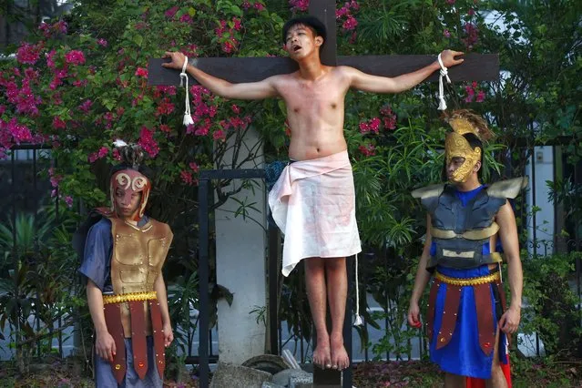 Filipino Catholics from a parish youth council perform in the “Senakulo”, a depiction of events in the crucifixion and death of Jesus Christ in observance of Good Friday of Lent at a residential village in Quezon City, Metro Manila, Philippines, 15 April 2022. Filipino Catholics join other faithful around the world in observing Holy Week in the Lent season which runs from Palm Sunday to Easter Sunday. (Photo by Rolex Dela Pena/EPA/EFE)