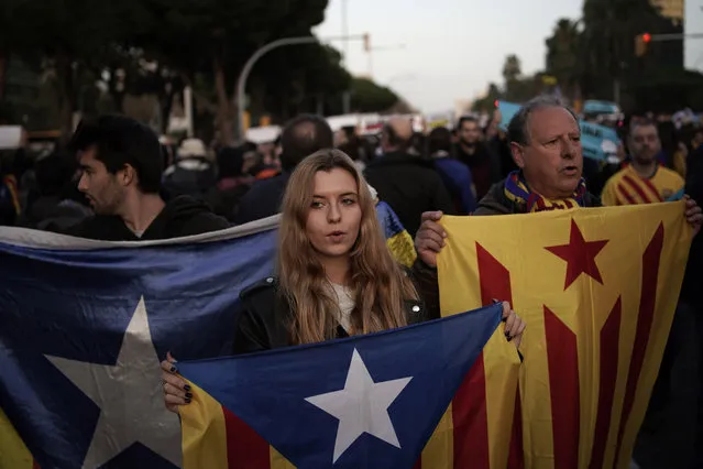 Catalan pro-independence demonstrators block a road as they protest outside the Camp Nou stadium ahead of a Spanish La Liga soccer match between Barcelona and Real Madrid in Barcelona, Spain, Wednesday, December 18, 2019. Thousands of Catalan separatists are planning to protest around and inside Barcelona's Camp Nou Stadium during Wednesday's match against fierce rival Real Madrid. (Photo by Felipe Dana/AP Photo)