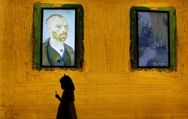 A girl walks past a display at the world premiere of “Meet Vincent van Gogh” exhibition in Beijing, China, June 15, 2016. (Photo by Kim Kyung-Hoon/Reuters)