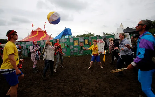 Revellers play with a ball at Worthy Farm in Somerset during the Glastonbury Festival, Britain, June 26, 2016. (Photo by Stoyan Nenov/Reuters)