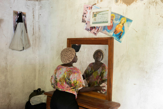 Coach Isabelle Sambou, 43 years old, two-time Olympian and nine-time African wrestling champion, cleans a mirror inside her room in Mlomp, southern Senegal, Wednesday, July 10, 2024. (Photo by Sylvain Cherkaoui/AP Photo)