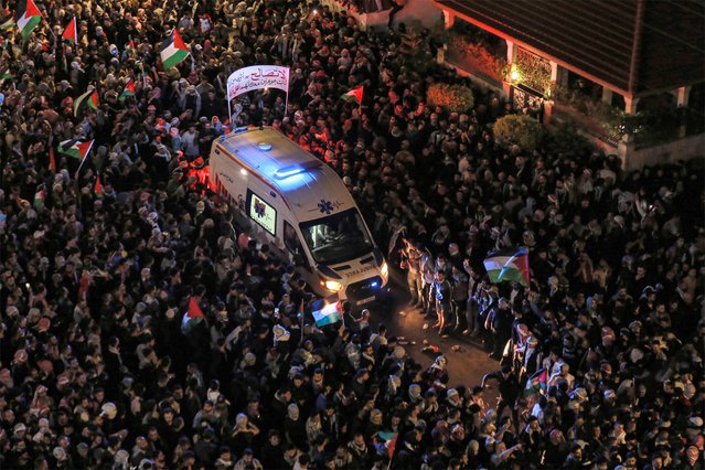 Demonstrators clear the way for an ambulance during a rally outside the Israeli embassy headquarters in Amman late on October 18, 2023 to show solidarity with the Palestinians of the Gaza Strip. Thousands rallied across the Arab and Muslim world on October 18 to protest the deaths of hundreds of people in a strike on a Gaza hospital that they blame on Israel, despite its denials. (Photo by Khalil Mazraawi/AFP Photo)