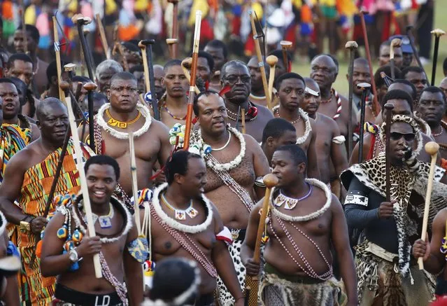 King Mswati III (C) arrives with his regiments after maidens delivered reeds at Ludzidzini royal palace during the annual Reed Dance in Swaziland, August 30, 2015. (Photo by Siphiwe Sibeko/Reuters)