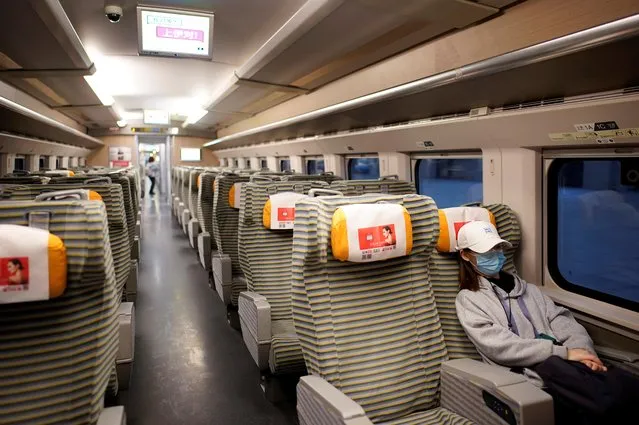 A passenger sits inside a high-speed train at Hankou Railway Station after travel restrictions to leave Wuhan, the capital of Hubei province and China's epicentre of the novel coronavirus disease (COVID-19) outbreak, were lifted, April 8, 2020. (Photo by Aly Song/Reuters)