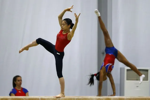 2016 Rio Olympics, Artistic gymnastics, Women's Training, Rio Athletes Park, Rio De Janeiro, Brazil on July 27, 2016. Gymnasts from Japan (C) and Cuba (R) train. (Photo by Ivan Alvarado/Reuters)