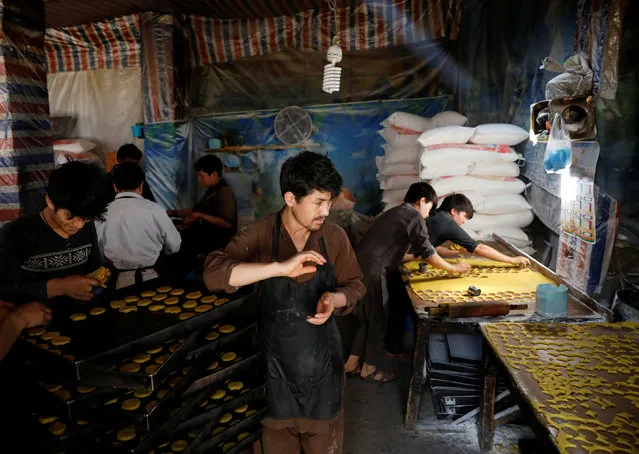 Men prepare cookies at a small traditional factory, ahead of the holy fasting month of Ramadan, amid the spread of the coronavirus disease (COVID-19), in Kabul, Afghanistan on April 23, 2020. (Photo by Mohammad Ismail/Reuters)