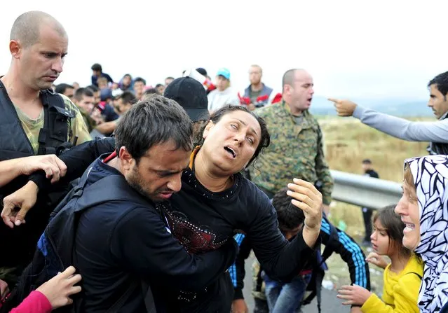 A group of migrants try to go through police blockades after entering Gevgelija, in Macedonia, after crossing the border from Greece September 10, 2015. Macedonia is considering building a Hungarian-style border fence to stem a rising influx of migrants from the south, Foreign Minister Nikola Poposki was quoted as saying on Thursday. (Photo by Tomislav Georgiev/Reuters)