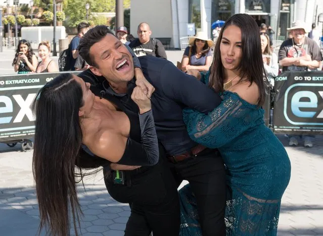 Nikki Bella and Brie Bella wrestle Mark Wright at “Extra” at Universal Studios Hollywood on October 26, 2017 in Universal City, California. (Photo by Noel Vasquez/Getty Images)