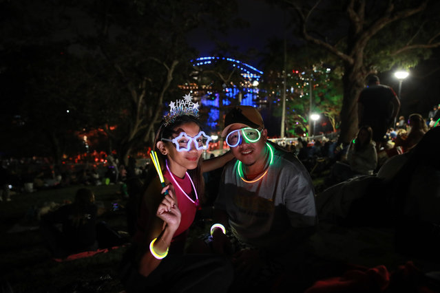 Crowds gather at Mrs Macquarie's Chair to watch the fireworks during New Year's Eve celebrations on December 31, 2023 in Sydney, Australia. Revellers turned out in large numbers to celebrate the new year in Australia. (Photo by Roni Bintang/Getty Images)