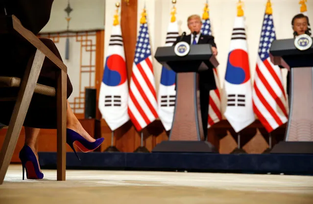 U.S. first lady Melania Trump, in purple high-heeled shoes, sits in the front row as U.S. President Donald Trump and South Korea's President Moon Jae-in hold a joint news conference the Blue House in Seoul, South Korea November 7, 2017. (Photo by Jonathan Ernst/Reuters)