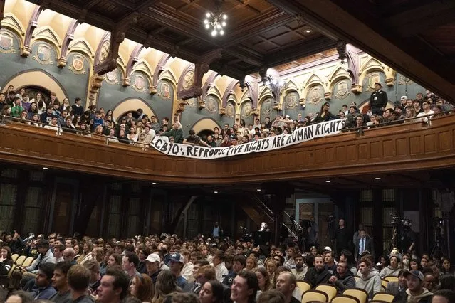 Students protest and unfurl a banner as former Vice President Mike Pence speak to students at Georgetown University in Washington, Wednesday, October 19, 2022. (Photo by Jose Luis Magana/AP Photo)