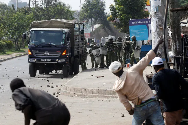 Supporters of Kenyan opposition National Super Alliance (NASA) coalition throw stones at police in Nairobi, Kenya on November 17, 2017. (Photo by Baz Ratner/Reuters)