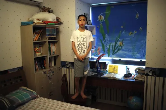 Yao Jihan, who was born in 2000, poses for a photograph in Shanghai July 27, 2014. When asked if he would like siblings Jihan said: “No. I don't know. Maybe, maybe, because it's troublesome. If there is one more person in this house, the room will not be big enough to hold two children. I don't feel lonely because I have a lot of friends”. (Photo by Carlos Barria/Reuters)