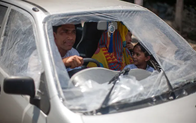 A Kashmir Muslim family negotiates a curfew in a car covered with plastic sheets after its window panes were broken in clashes between Indian government forces and Kashmiri Muslims, following weeks of violence that has left over 67 people dead and thousands injured on August 21, 2016 in Srinagar, the summer capital of Indian administered Kashmir, India. Indian authorities have sealed all the streets and roads in Kashmir to impose strict curfew on the 44th day and to thwart anti Indian and pro Kashmir freedom protest marches, which aims to protest against the killing of innocents in the valley. Currently 67 died and over 6,000 have been injured during the fierce protests over the killing of a young rebel commander Burhan Wani. The violence in the area is the worst since 2010 and the protests have triggered a heavy crackdown by Indian government forces which include many strict curfews. (Photo by Yawar Nazir/Getty Images)