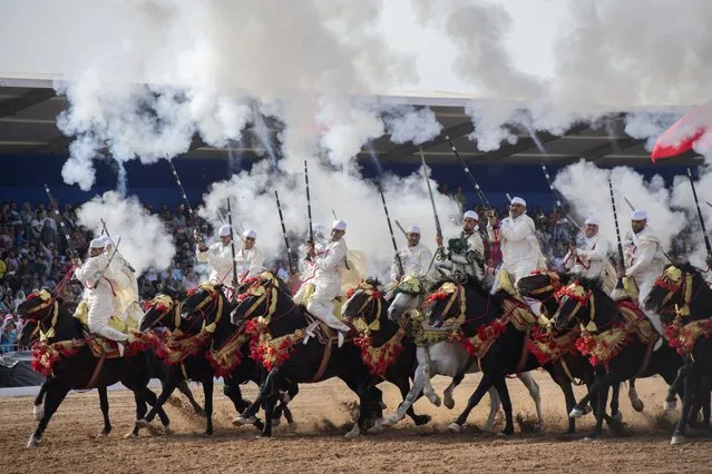 Horsemen charge and fire their rifles loaded with gunpowder during a national competition of “Tabourida”, a traditional horse riding show also known as 'Fantasia, salon du cheval d'El Jadida' (El Jadida International Horse Show), in El Jadida, Morocco, 21 October 2022. (Photo by Jalal Morchidi/EPA/EFE)