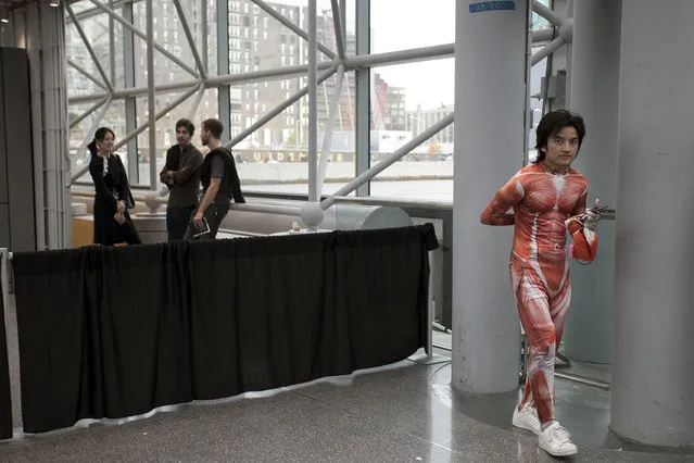 An attendee dressed as a titan from the anime series “Attack on Titan” inside New York's Comic-Con convention. (Photo by Siemond Chan)