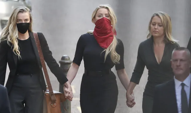 Actress Amber Heard, center, arrives at the High Court in London, Tuesday, July 7, 2020. Johnny Depp has a starring role in a real-life courtroom drama in London, where he is suing a tabloid newspaper for libel over an article that branded him a “wife beater”. On Tuesday, a judge at the High Court is due to begin hearing Depp's claim against The Sun's publisher, News Group Newspapers, and its executive editor, Dan Wootton, over the 2018 story alleging he was violent and abusive to then-wife Amber Heard. Depp strongly denies the claim. (Photo by Alastair Grant/AP Photo)