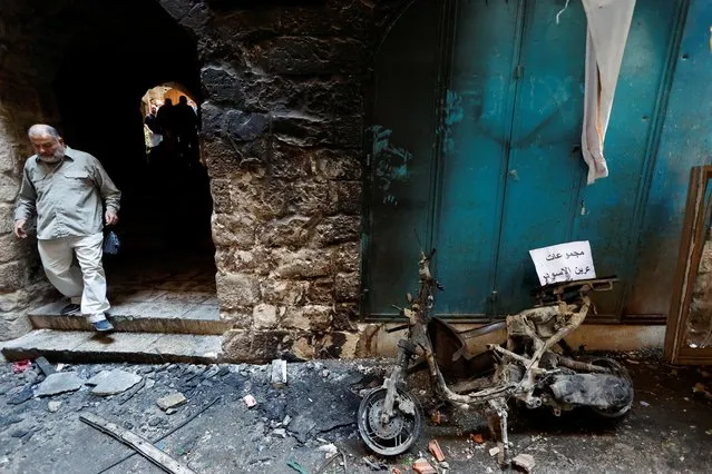 A burned vehicle is seen outside the house of Palestinian group Lions' Den member Wadee Al-Houh, which was targeted during a raid by Israeli security forces, in Nablus in the Israeli-occupied West Bank on October 25, 2022. (Photo by Raneen Sawafta/Reuters)