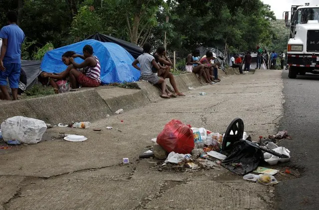 Africans migrants stranded in Costa Rica sit near garbage on the Inter-American highway in the border between Costa Rica and Nicaragua, in Penas Blancas, Costa Rica, September 7, 2016. (Photo by Juan Carlos Ulate/Reuters)