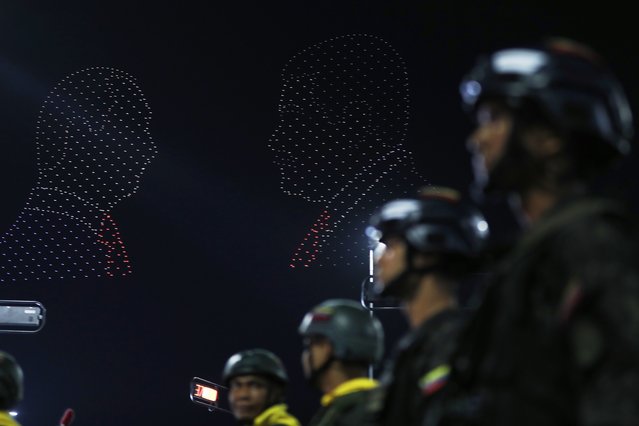 The silhouettes of Venezuela's President Nicolás Maduro and Russian President Vladimir Putin, left, are projected during the inauguration of a monument marking the 80th anniversary of the Soviet Union's victory over Nazi Germany in World War II in Caracas, Venezuela, Tuesday, May 13, 2025.. (Photo by Cristian Hernandez/AP Photo)