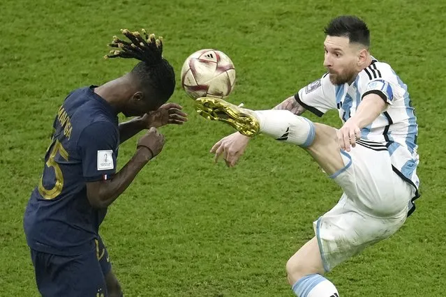 Argentina's Lionel Messi, right, and France's Eduardo Camavinga, left, fight for the ball during the World Cup final soccer match between Argentina and France at the Lusail Stadium in Lusail, Qatar, Sunday, December 18, 2022. (Photo by Christophe Ena/AP Photo)