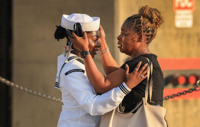 LaurAnna Dyson (L) says goodbye to her cousin, Janae Sturgis, as she prepares to board the aircraft carrier USS Gerald R. Ford at the Naval Station Norfolk on June 24, 2025, in Norfolk, Virginia. The aircraft carrier is leaving on its scheduled deployment to the U.S. European Command area of responsibility. The deployment comes during the ongoing conflict in the Middle East between Israel and Iran. (Photo by Joe Raedle/Getty Images)