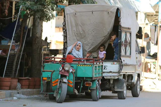 People ride a vehicle in the rebel-held al-Shaar neighbourhood of Aleppo, Syria, September 17, 2016. (Photo by Abdalrhman Ismail/Reuters)