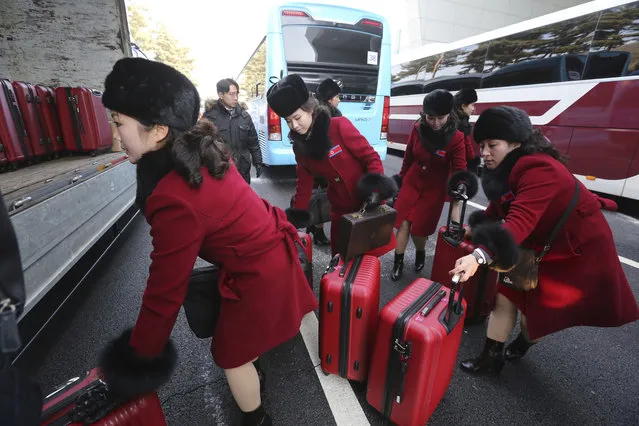 North Korean cheering squads carry suitcases upon their arrival at the Korean-transit office near the Demilitarized Zone in Paju, South Korea, Wednesday, February 7, 2018. (Photo by Ahn Young-joon/AP Photo)