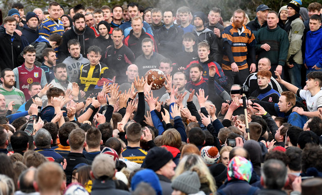 Rival teams “Up'ards” and “Down'ards” battle for the ball during the Royal Shrovetide Football match in Ashbourne, Derbyshire, England on February 13, 2018. For two days, over Shrove Tuesday and Ash Wednesday, hundreds of participants battle it out in a “no rules” game dating back to the 17th Century where the aim is to get a ball into one of two goals that are positioned three miles apart at either end of Ashbourne.  (Photo by Gareth Copley/Getty Images)