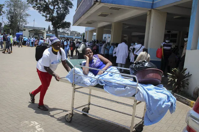 A patient is wheeled out of the Accident and Emergency ward after medical workers downed tools over poor pay and allowances at Kenya's largest referral hospital Kenyatta National Hospital in Nairobi, Kenya Monday, September 28, 2020. A witness says a man has died outside an emergency ward of Kenya's largest referral hospital after he was not treated for hours because the staff are on strike over pay raises that were approved in 2012 but according to medical workers not received. (Photo by AP Photo/Stringer)