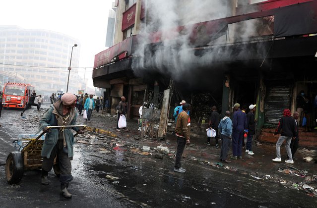 People react as they look at business premises burnt during demonstrations to mark the first anniversary of the deadly 2024 anti-government protests that drew widespread condemnation over the use of force by security agencies, in downtown Nairobi, Kenya on June 26, 2025. (Photo by Monicah Mwangi/Reuters)